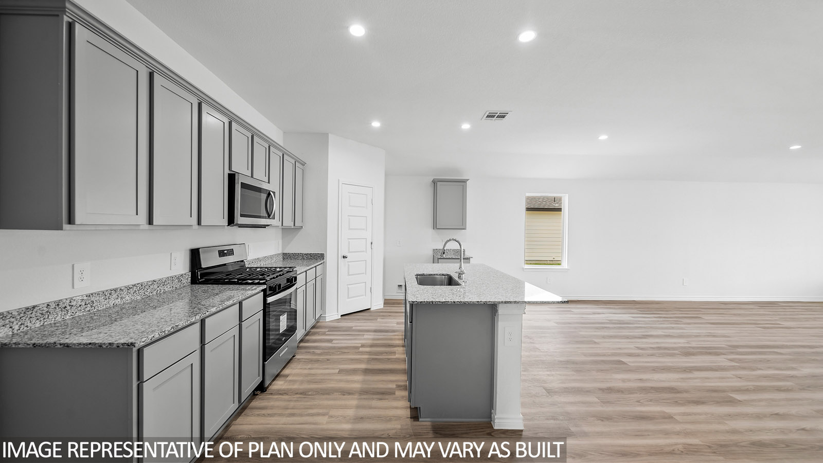 Gaven open kitchen with gray cabinets and granite countertops.