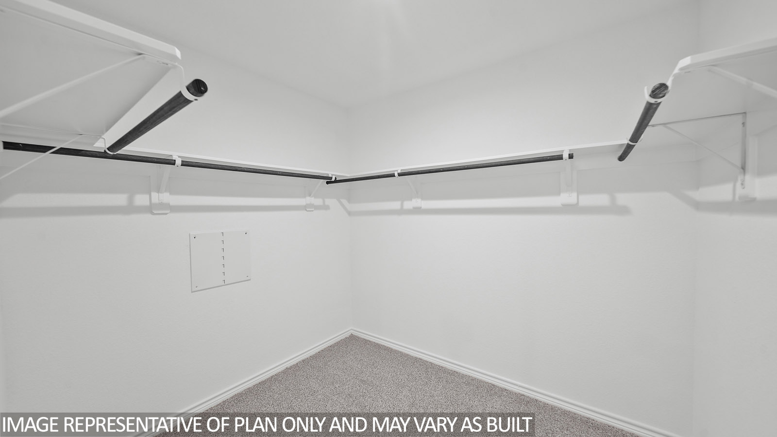 Gaven primary walk-in closet with carpet flooring and ample storage space.