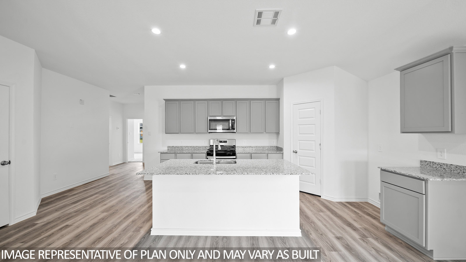 Gaven kitchen with spacious island and gray cabinets.