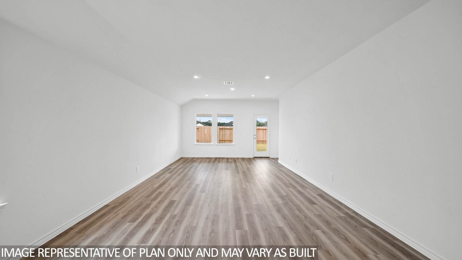 Gaven living room with vinly plank flooring and windows to the backyard.