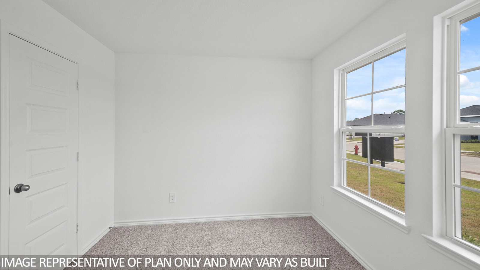 Gaven secondary bedroom with carpet flooring and window.