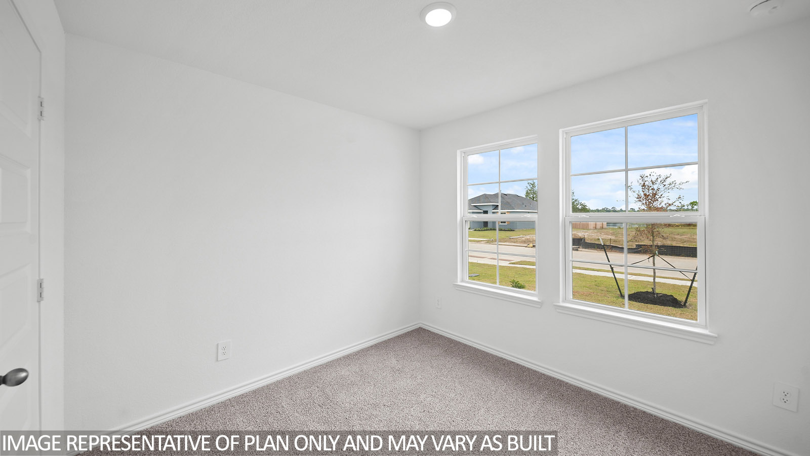 Gaven secondary bedroom with carpet flooring and window.