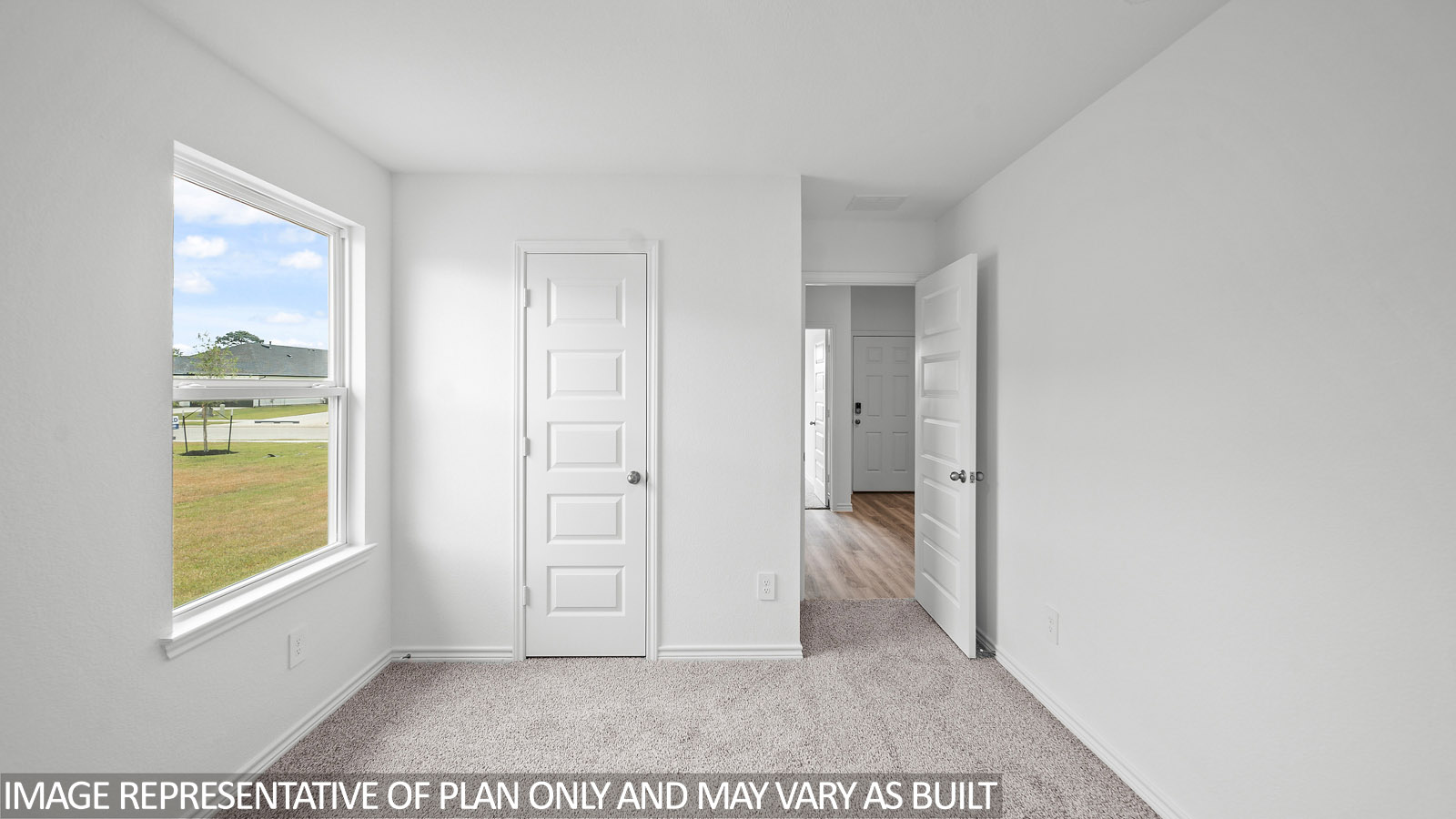 Gaven secondary bedroom with carpet flooring and window.