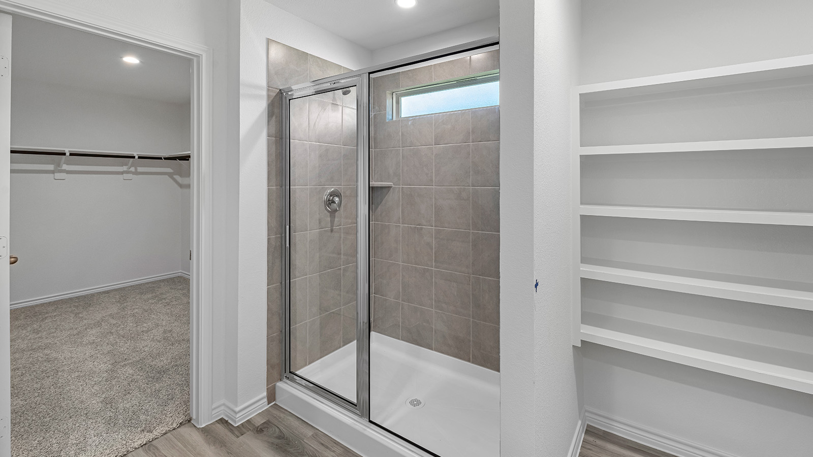 Harris primary bathroom with walk-in shower and view of primary walk-in closet.