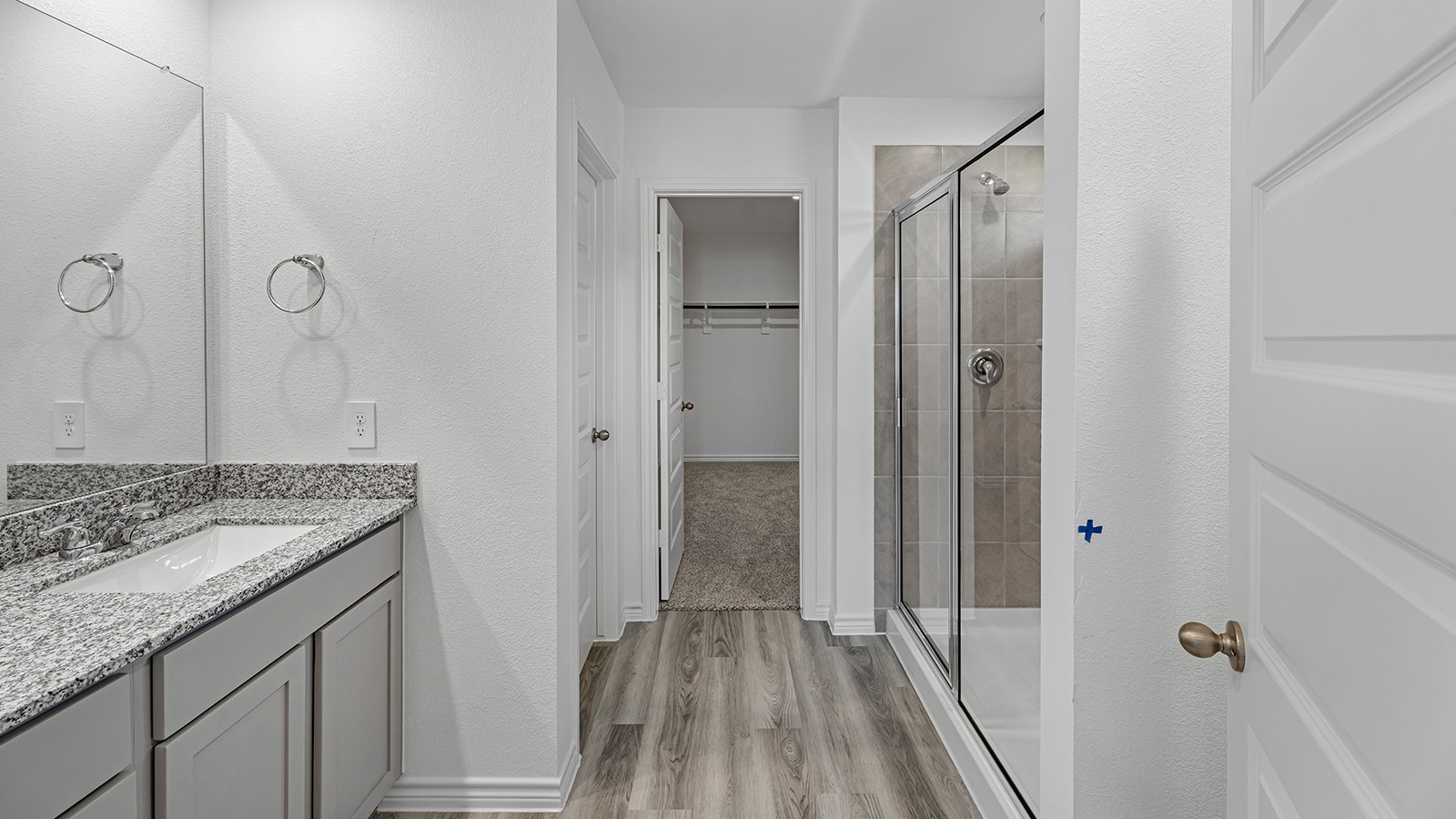 Harris primary bathroom with double vanity sink and walk-in shower.