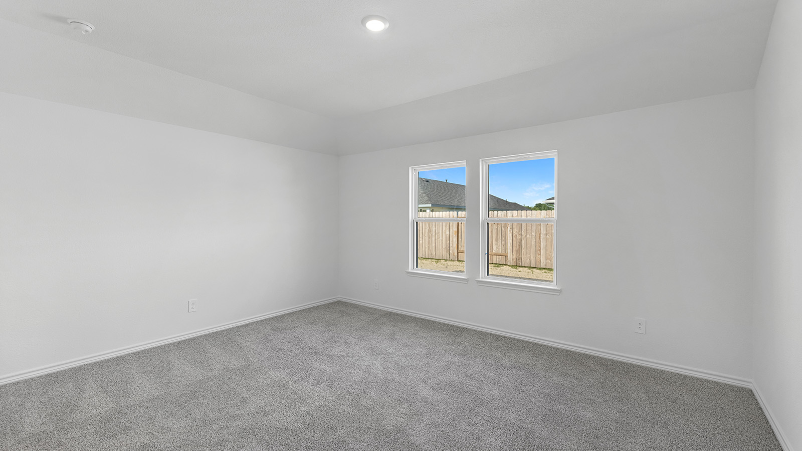 Harris primary bedroom with carpet flooring and window.
