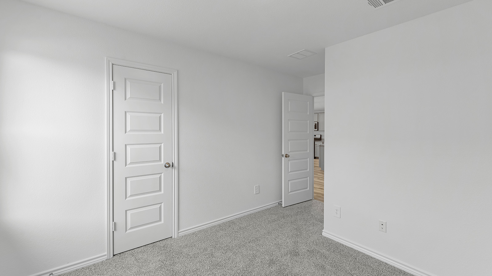 Harris secondary bedroom with carpet flooring and closet door.