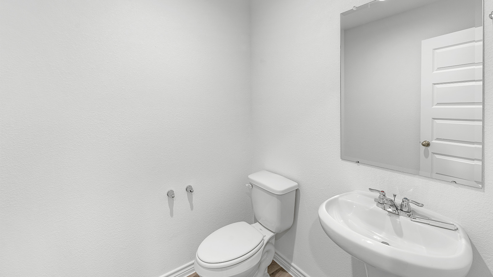 Harris secondary bathroom with vanity sink and mirror.
