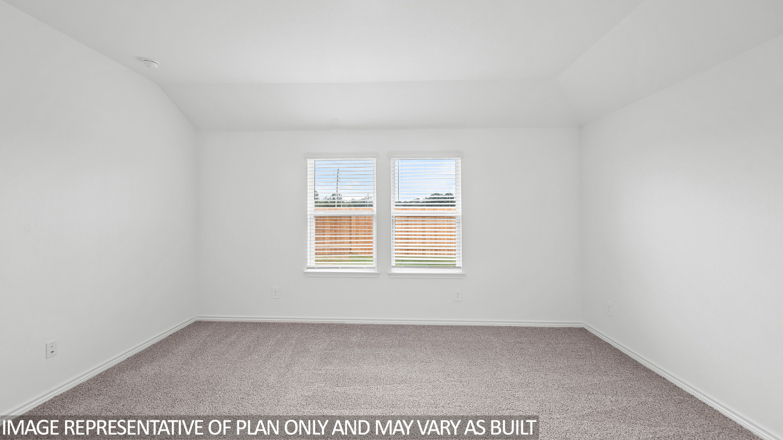 Harris primary bedroom with carpet flooring and windows to backyard.
