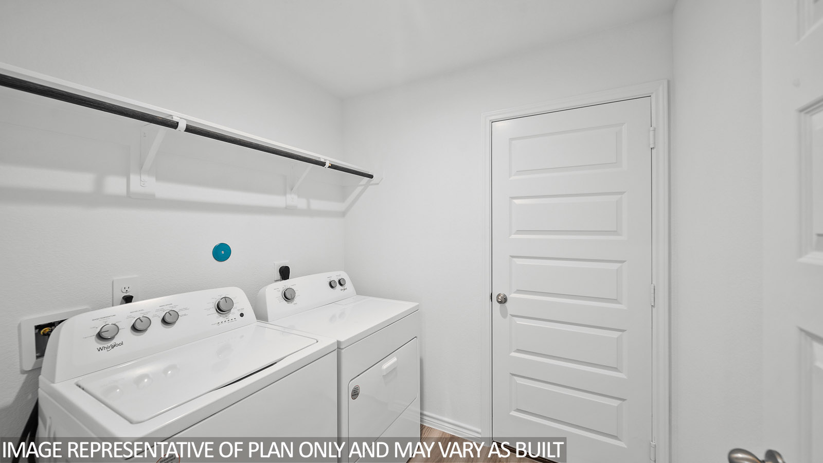 Harris utility room with washer and dryer and shelf with hanging rod.