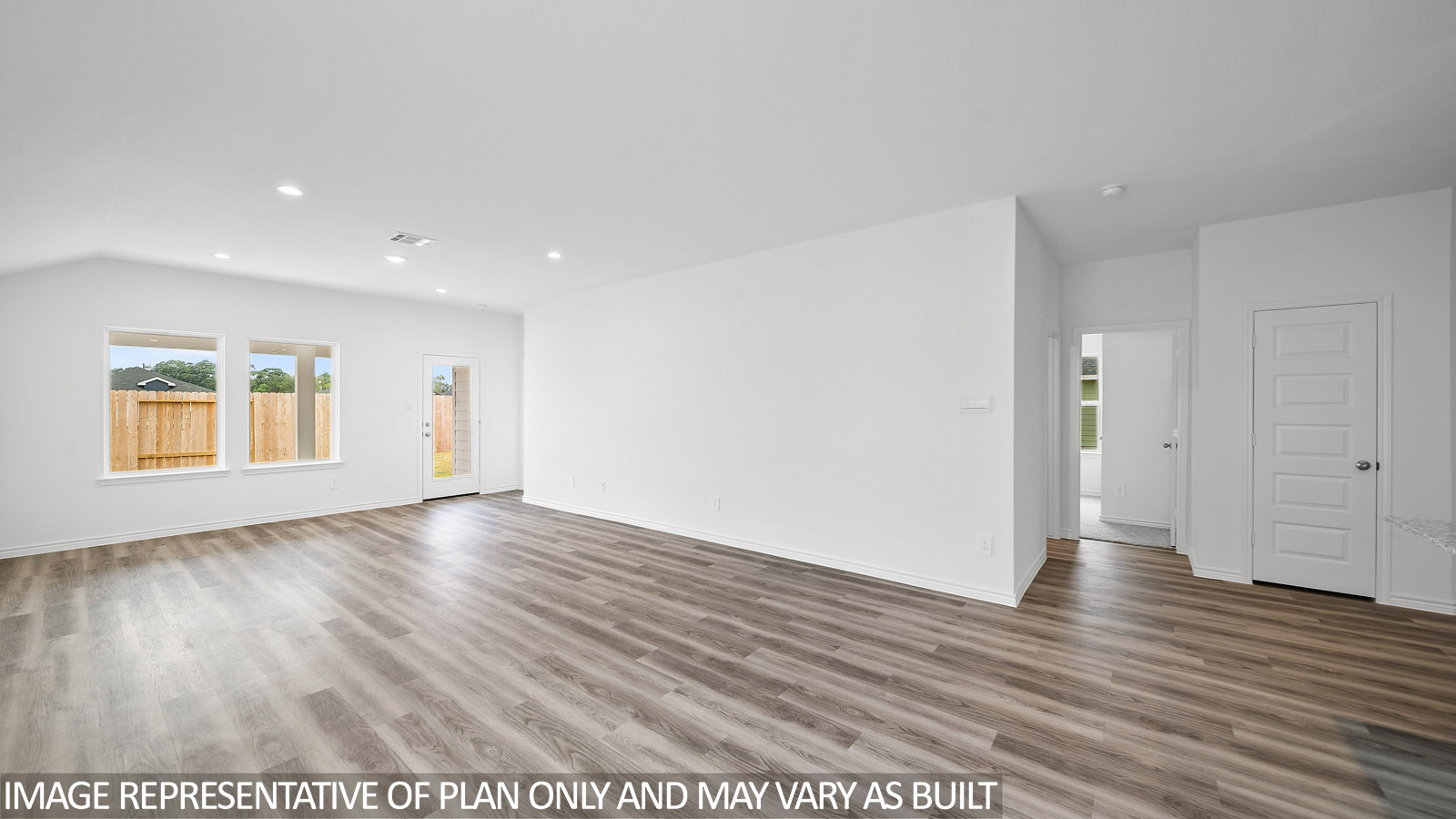 Gaven living room with vinly plank flooring and windows to the backyard.