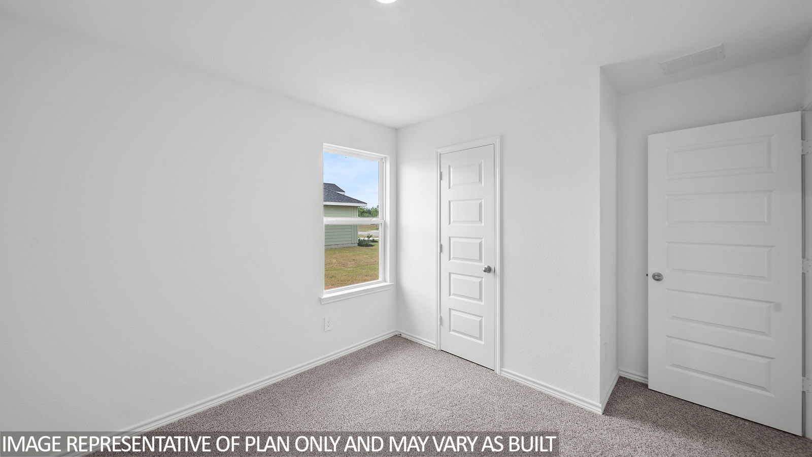 Gaven secondary bedroom with carpet flooring and window.