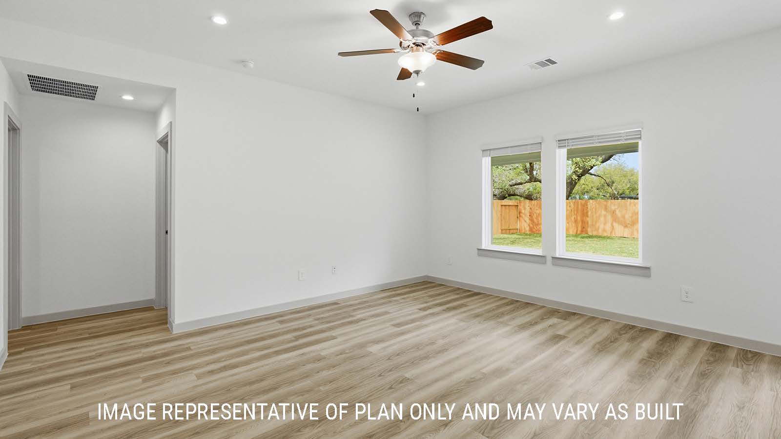 Bellvue dining room with vinyl plank flooring and windows for natural lighting with view of the back yard.