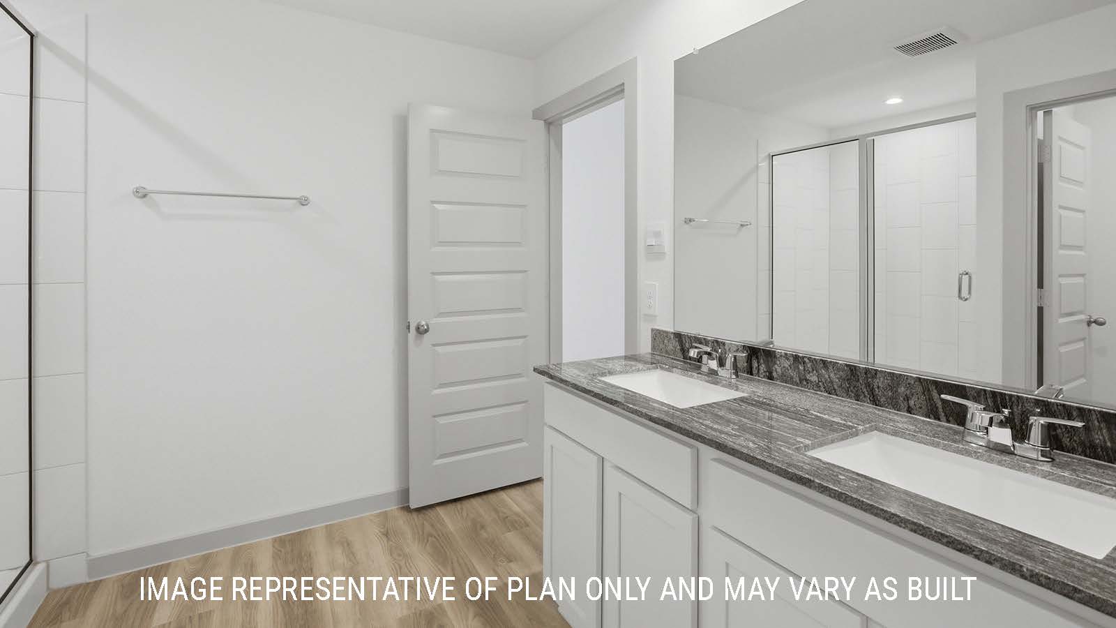 Bellvue primary bathroom with double vanity sink and view of primary bedroom.
