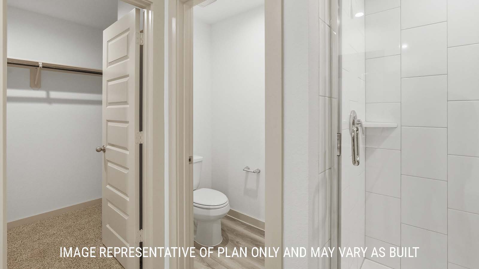 Bellvue primary bathroom with walk-in shower and view of primary bedroom walk-in closet.