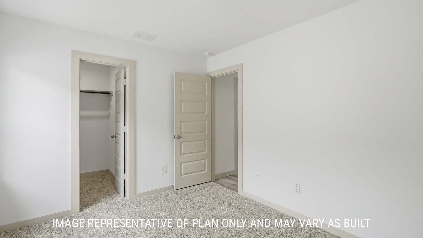 Bellvue secondary bedroom with carpeted flooring and closet with view of front entry way.