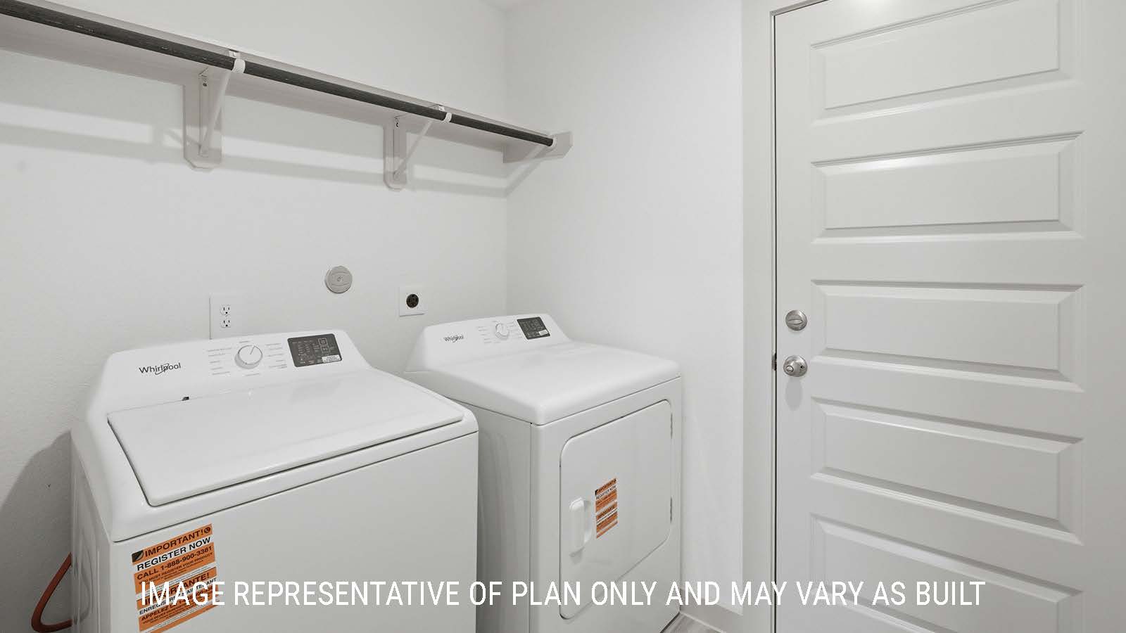 Bellvue utility room with washer and dryer connections with shelving for storage.