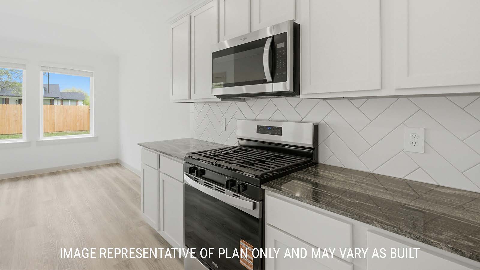 Bellvue kitchen with light cabinets and dark granite countertops with view of open concept dining room.