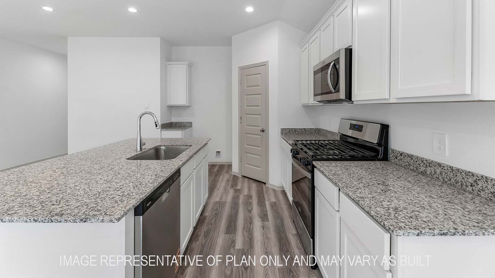 Bellvue kitchen with light cabinets and granite countertops.