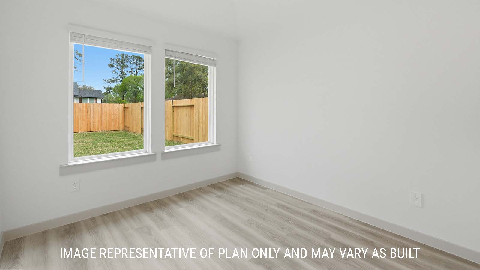 Bellvue dining room with vinyl plank flooring and windows for natural lighting with view of the back yard.
