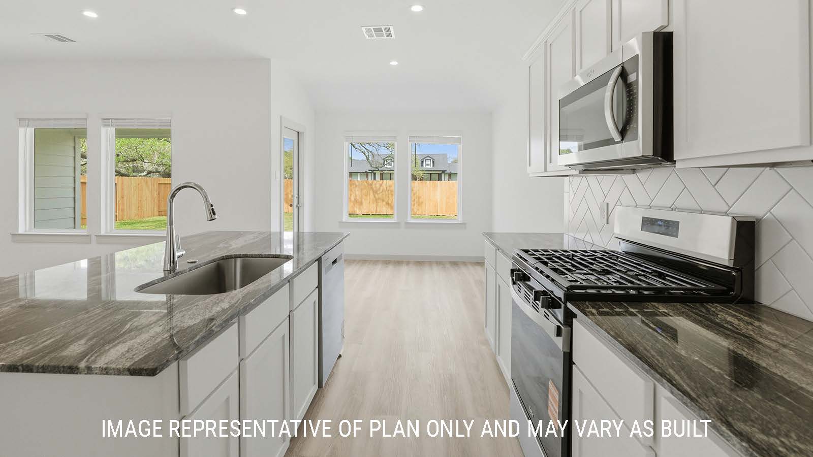 Bellvue kitchen with kitchen island with dark granite countertops and view of open concept living room.