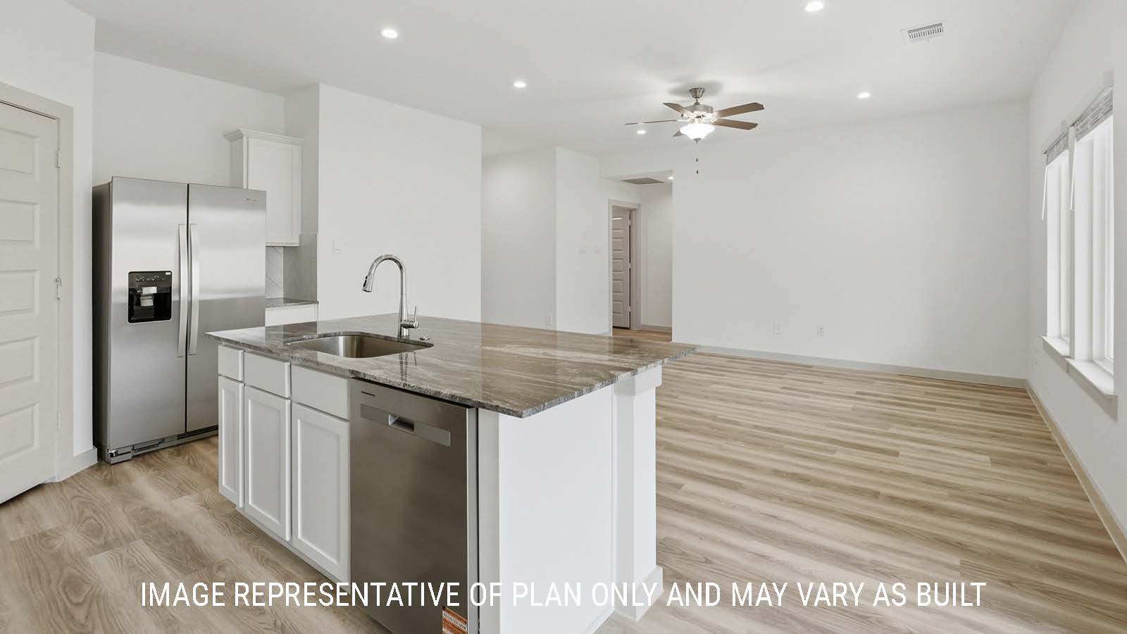 Bellvue kitchen with kitchen island with dark granite countertops and view of open concept living room.
