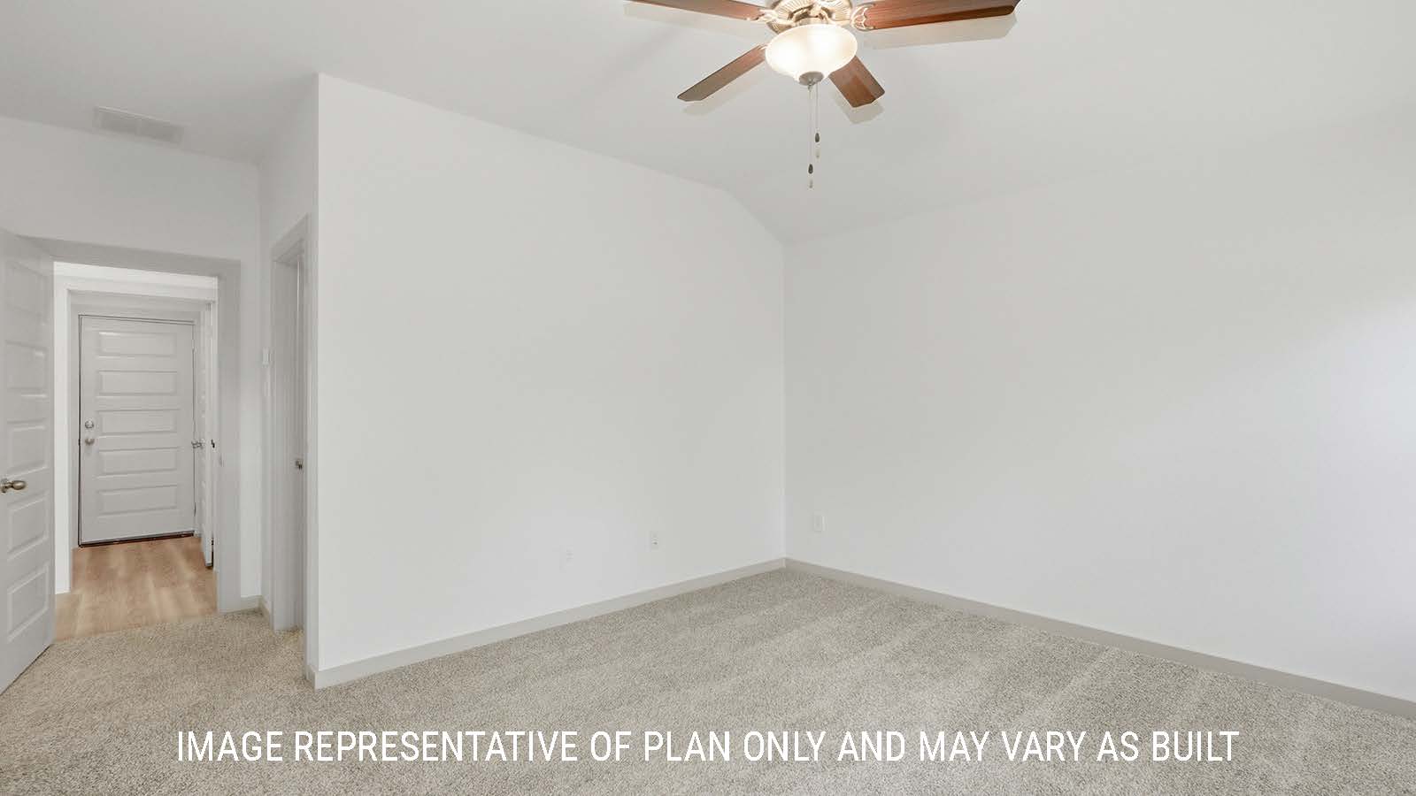 Bellvue primary bedroom with carpeted flooring and view of primary bathroom.