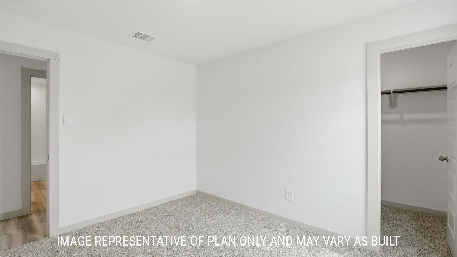 Bellvue secondary bedroom with carpeted flooring and closet with view of front entry way.