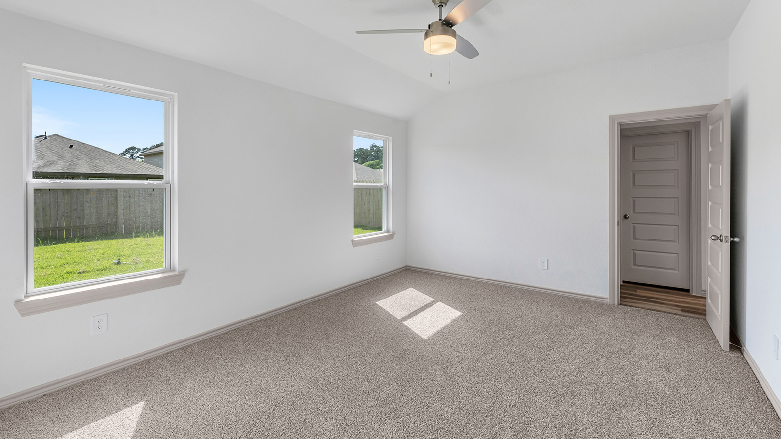 Camden living room open concept with windows and view of backyard.