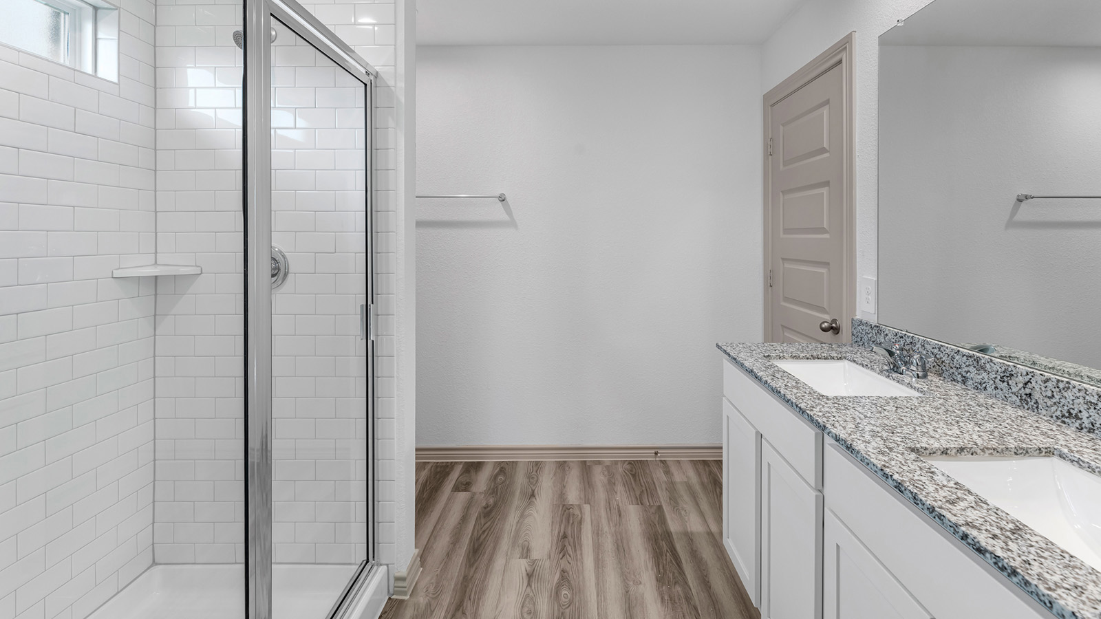 Camden primary bedroom with windows and carpet flooring.