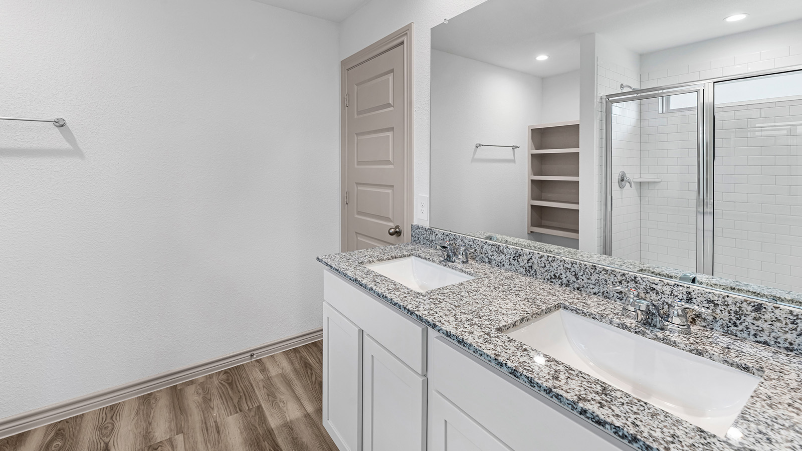 Camden primary bathroom with dual vanity sinks and walk-in shower.