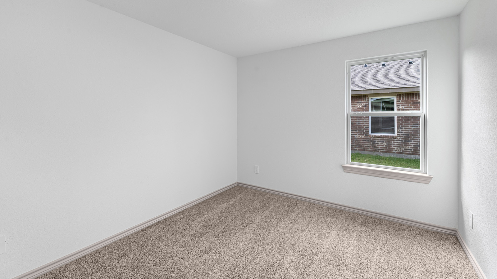 Camden secondary bedroom with carpet flooring and closet door.