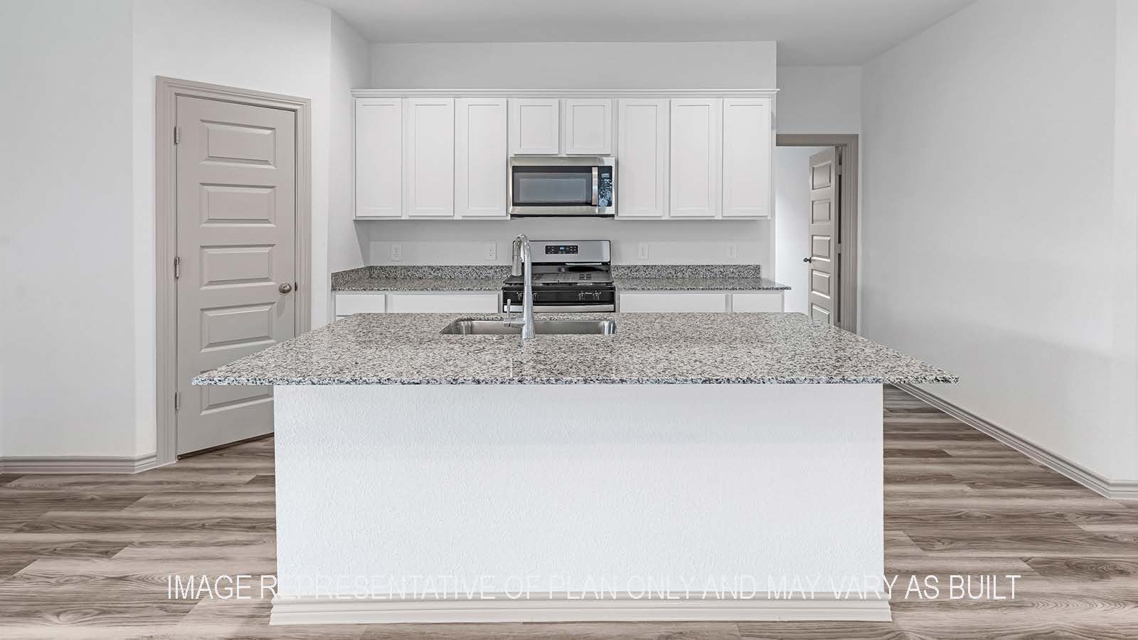 Camden kitchen island with granite countertops and view of hallway.