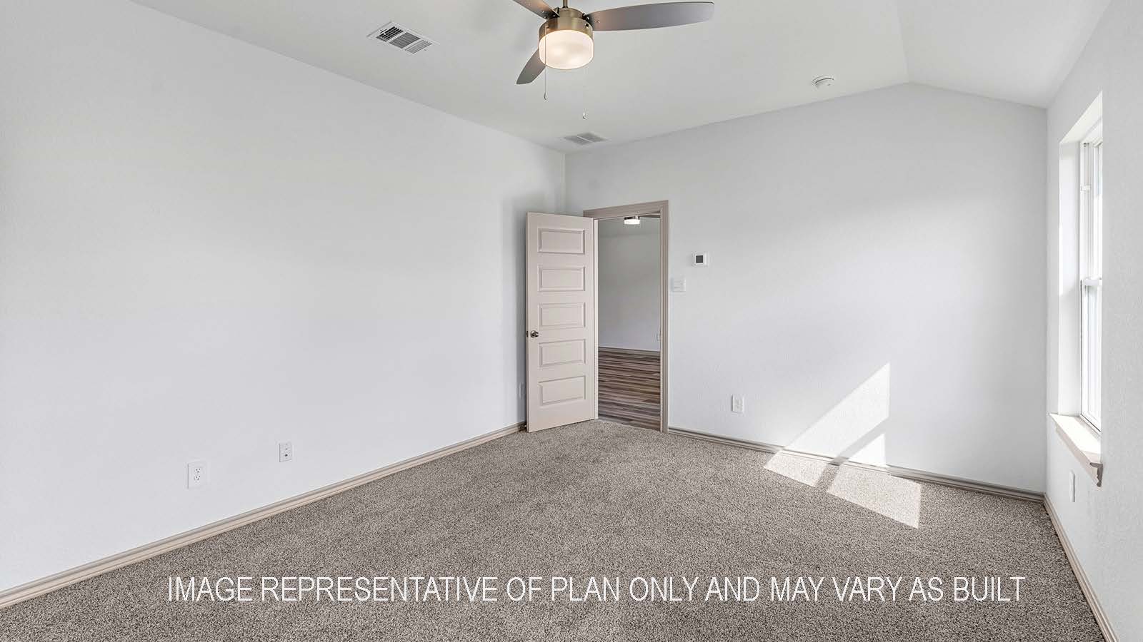 Camden secondary bedroom with carpet flooring and view of living room.