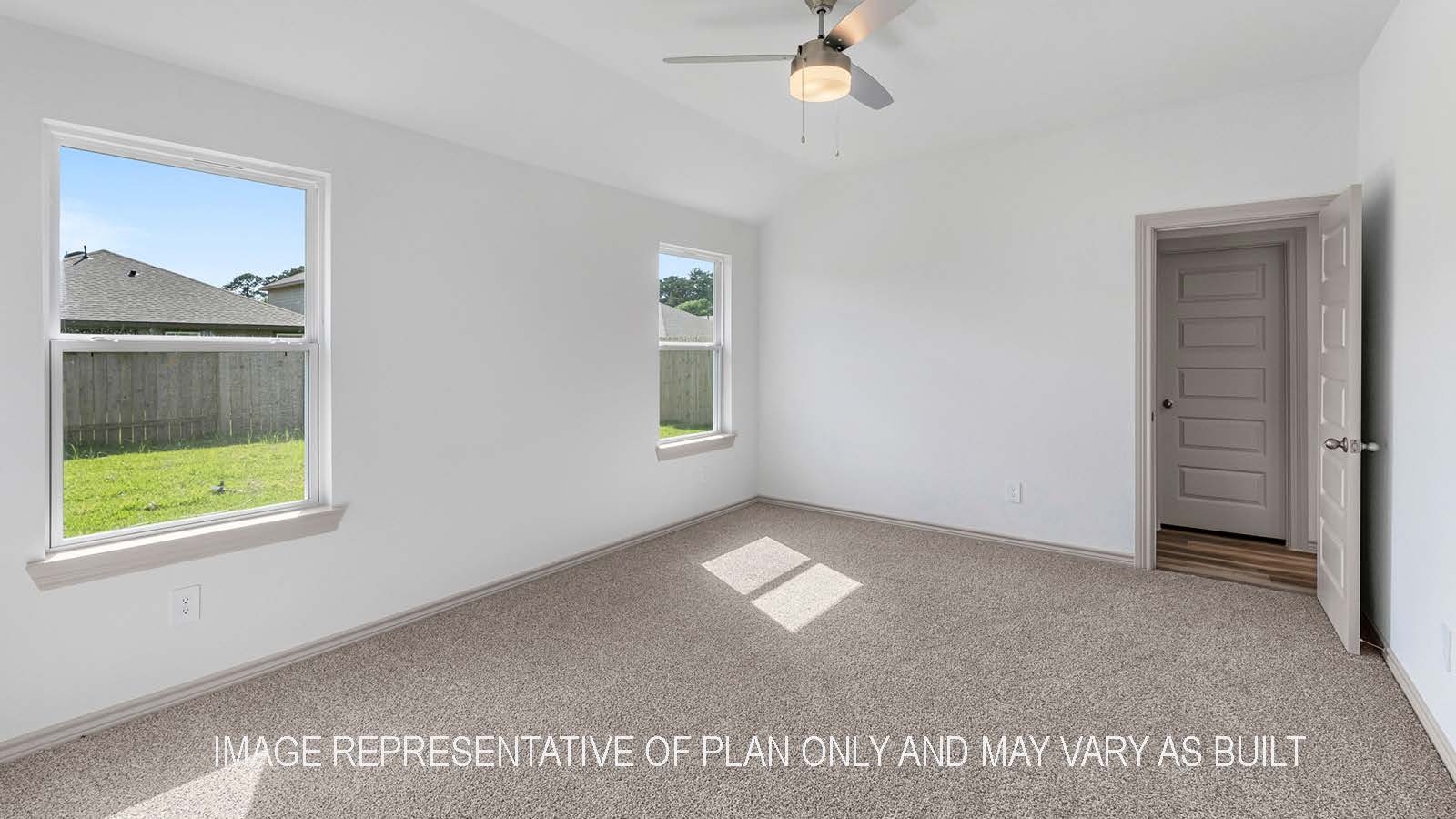 Camden primary bedroom with windows and carpet flooring.
