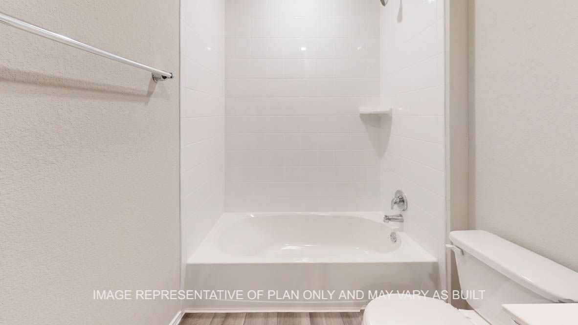 Elgin secondary bathroom with tub and shower combination.