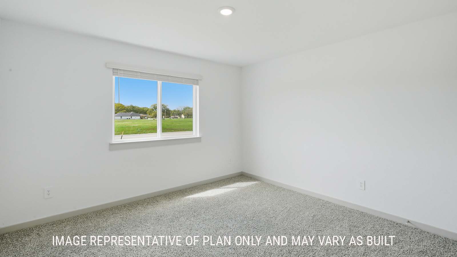 Elgin secondary bedroom with carpeted flooring and window for natural lighting.
