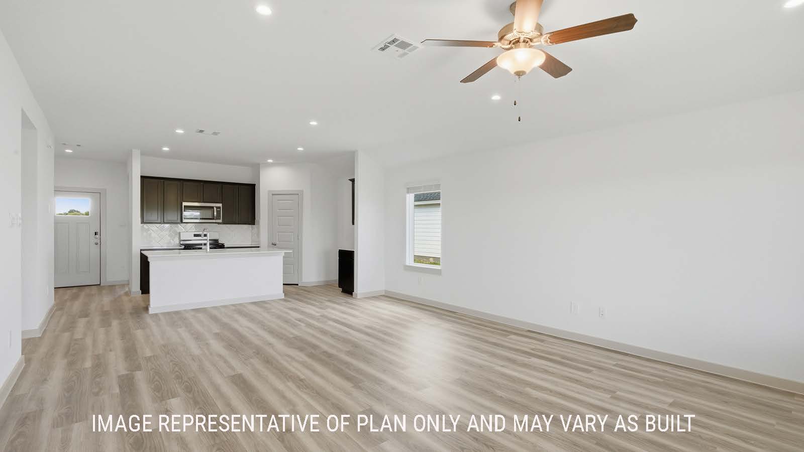 Elgin living room with vinyl plank flooring and view of open concept dining room and kitchen.