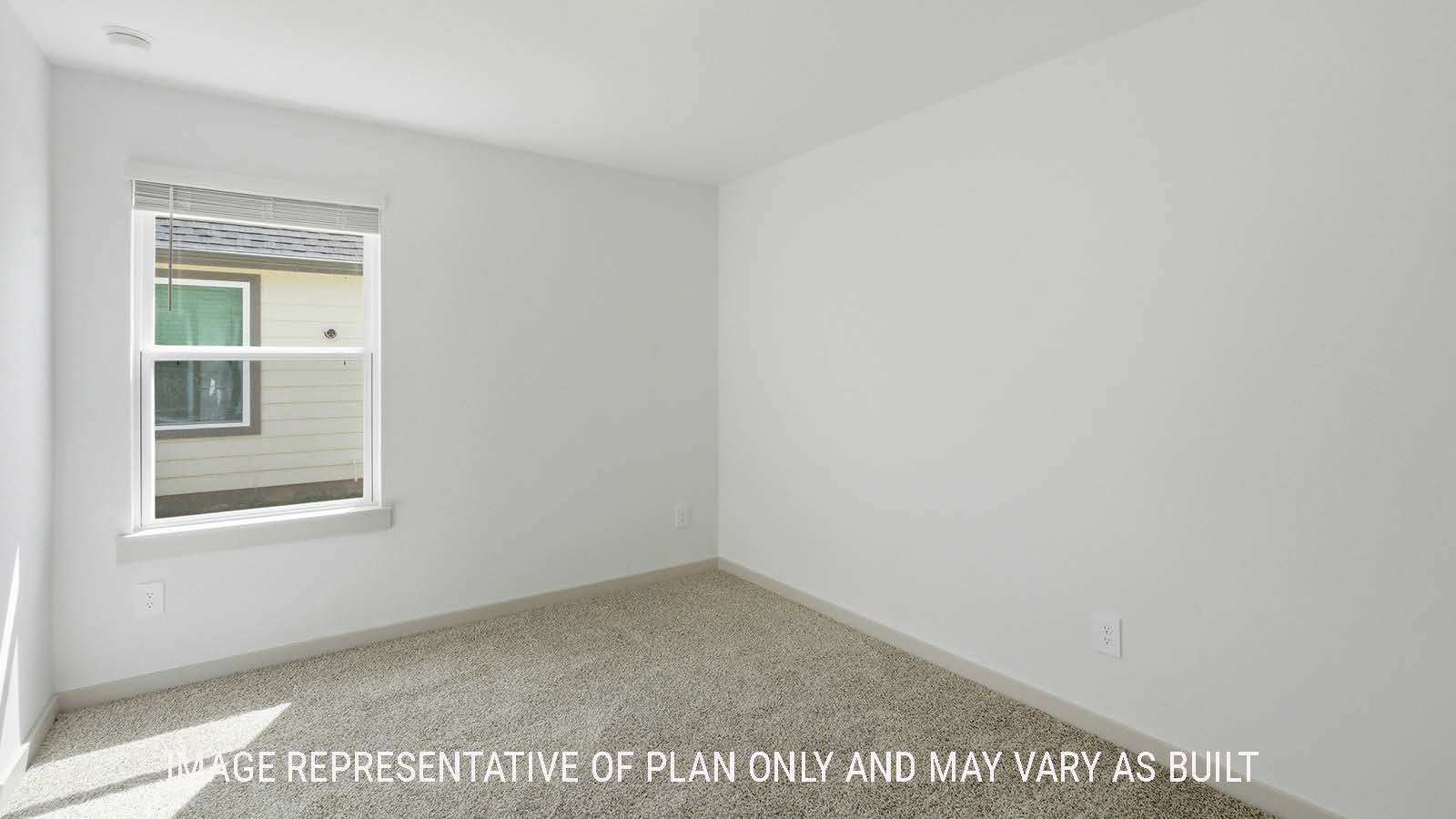 Elgin secondary bedroom with carpeted flooring and window for natural lighting.