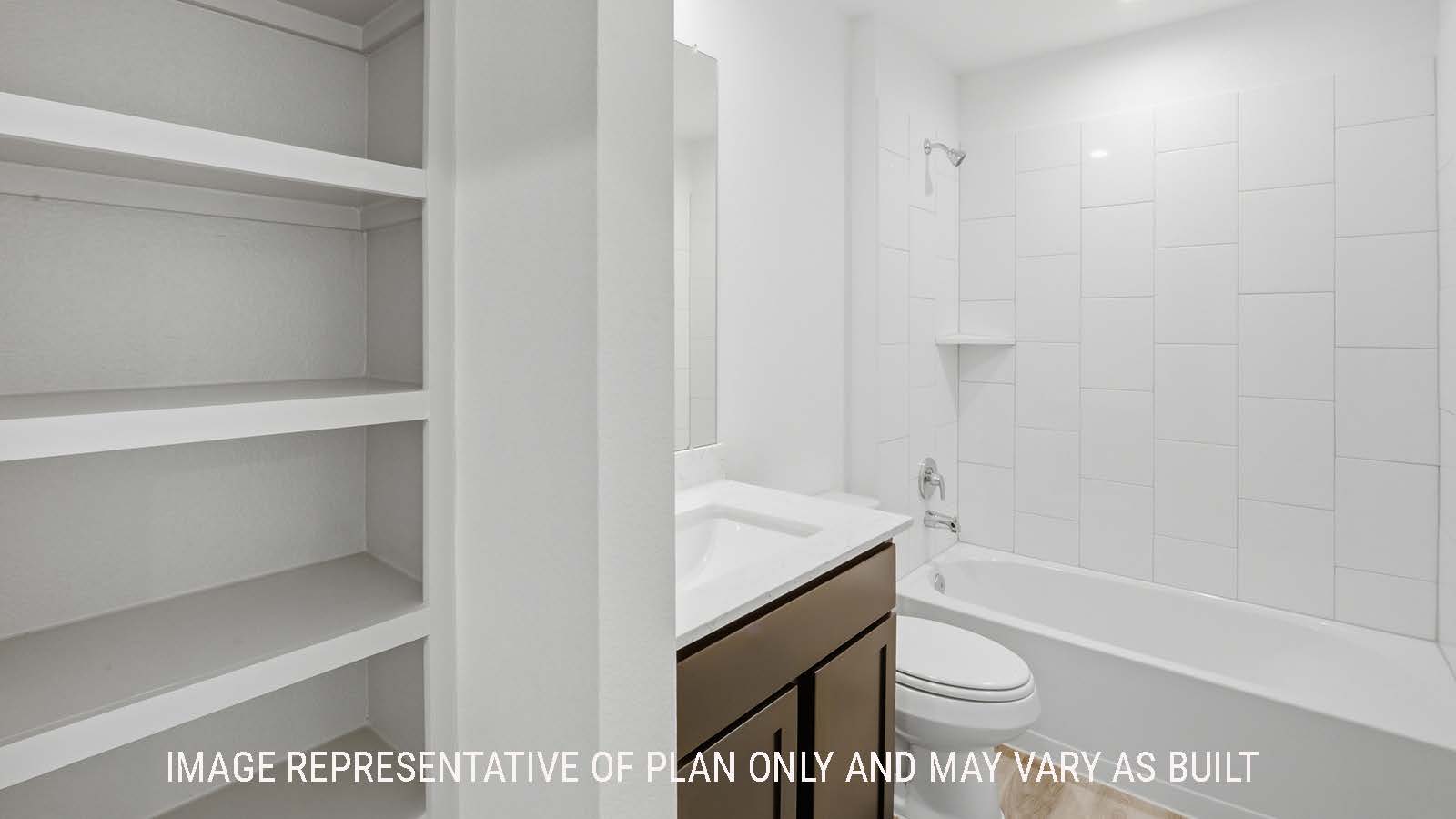 Elgin secondary bathroom with shelving for storage and vanity sink.