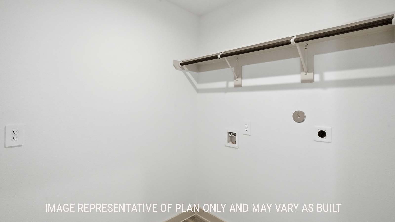 Elgin utility room with washer and dryer connections and shelving for storage.