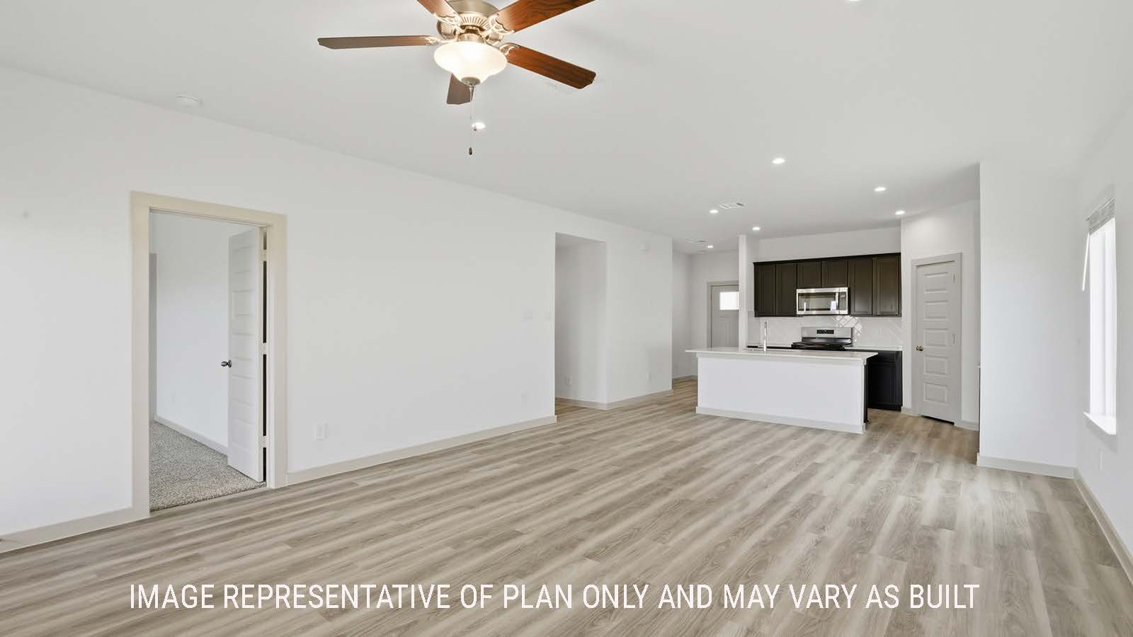 Elgin living room with vinyl plank flooring and view of open concept dining room and kitchen.