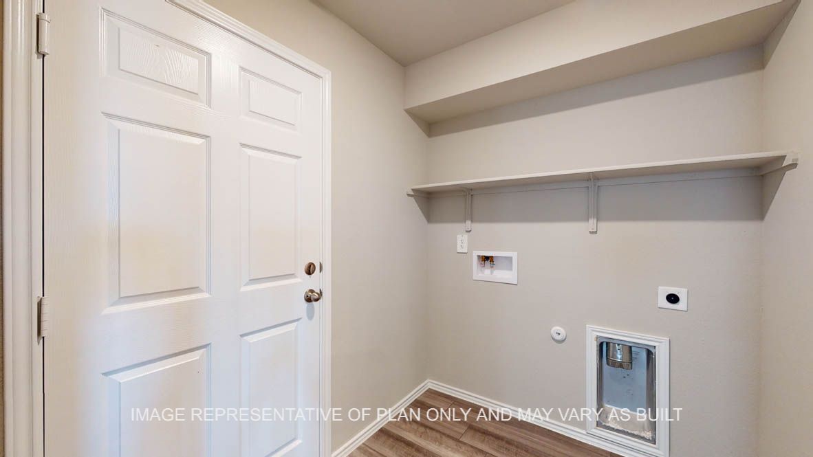 Fargo utility room with vinyl plank flooring and storage shelf.