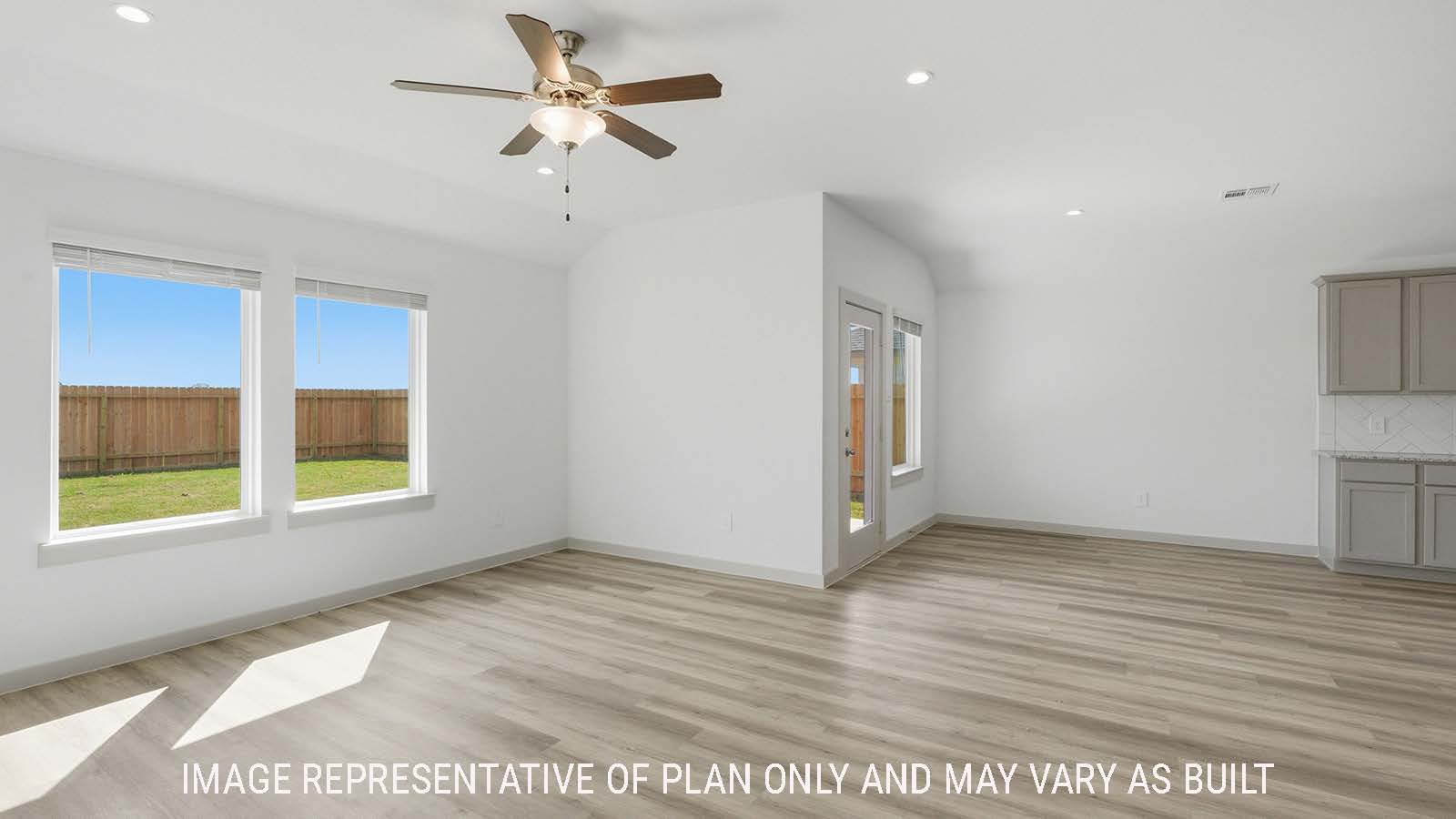 Texas Cali living room with vinyl plank flooring and windows for natural lighting.