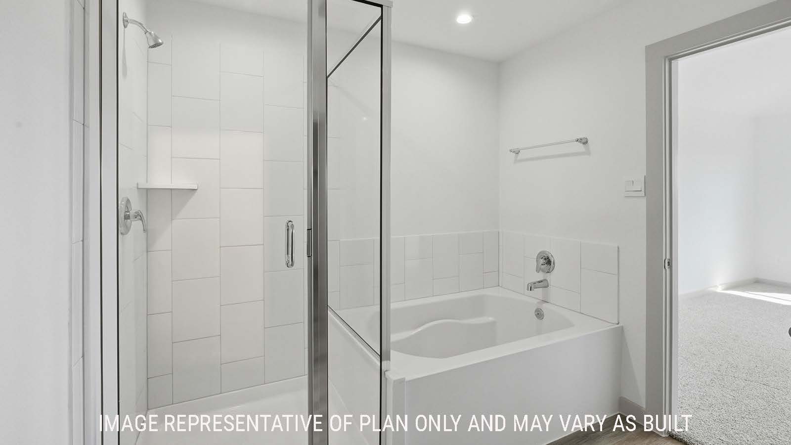 Texas Cali primary bathroom with garden tub and walk-in shower with view of primary bedroom.