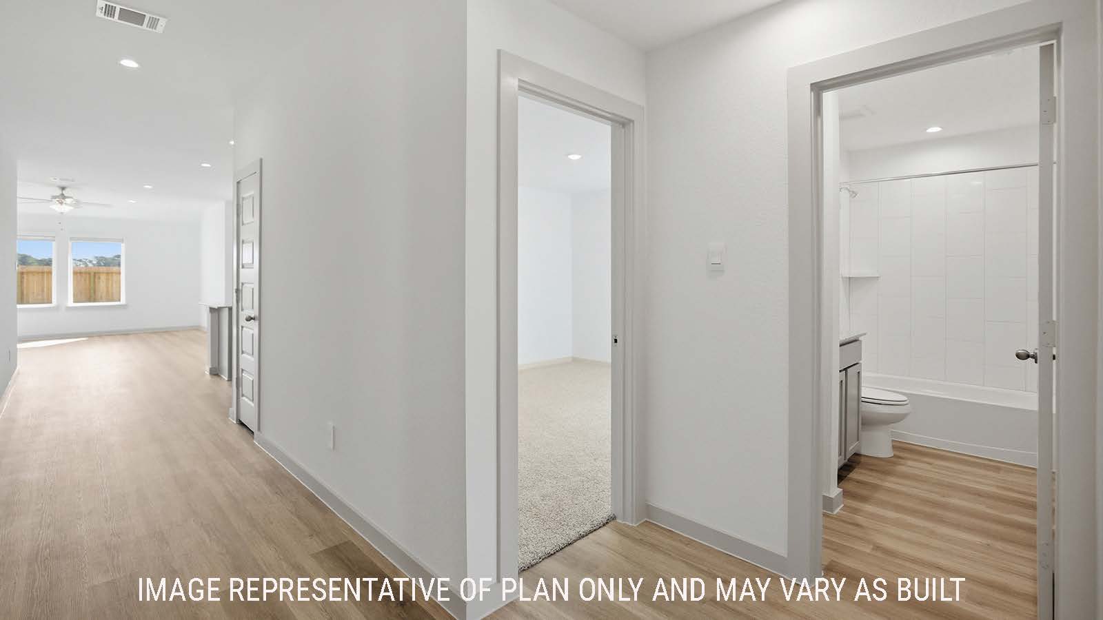 Texas Cali entry with vinyl plank flooring and view of open concept kitchen and living room.