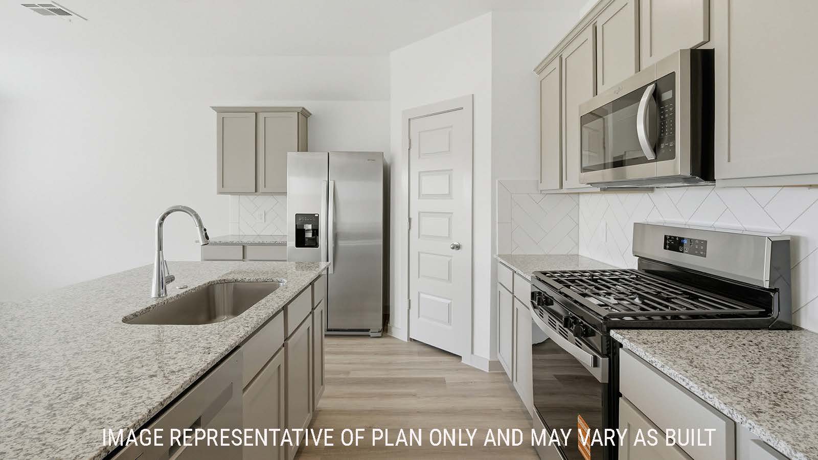 Texas Cali kitchen with light cabinets and granite countertops with stainless steel appliances.