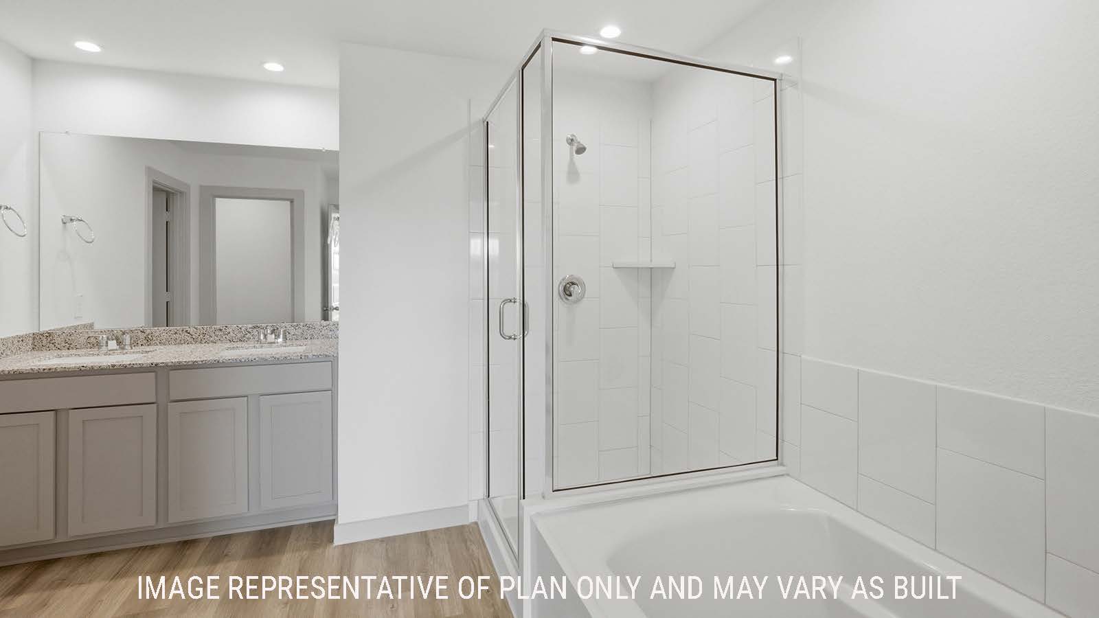Texas Cali primary bathroom with garden tub and walk-in shower and view of double vanity sink.