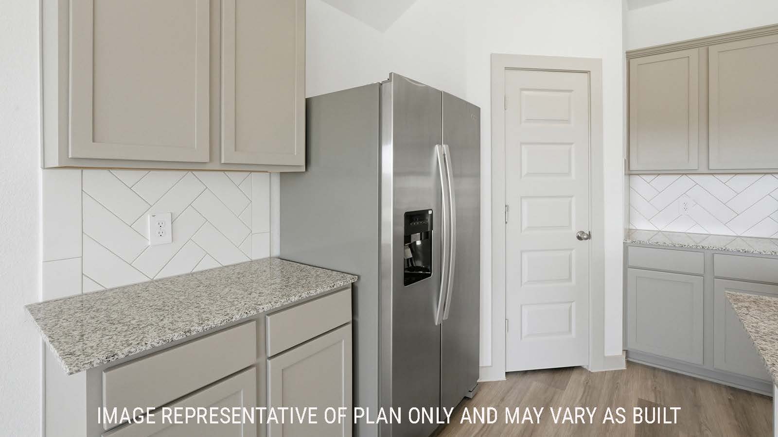 Texas Cali kitchen with light cabinets and granite countertops with stainless steel appliances.