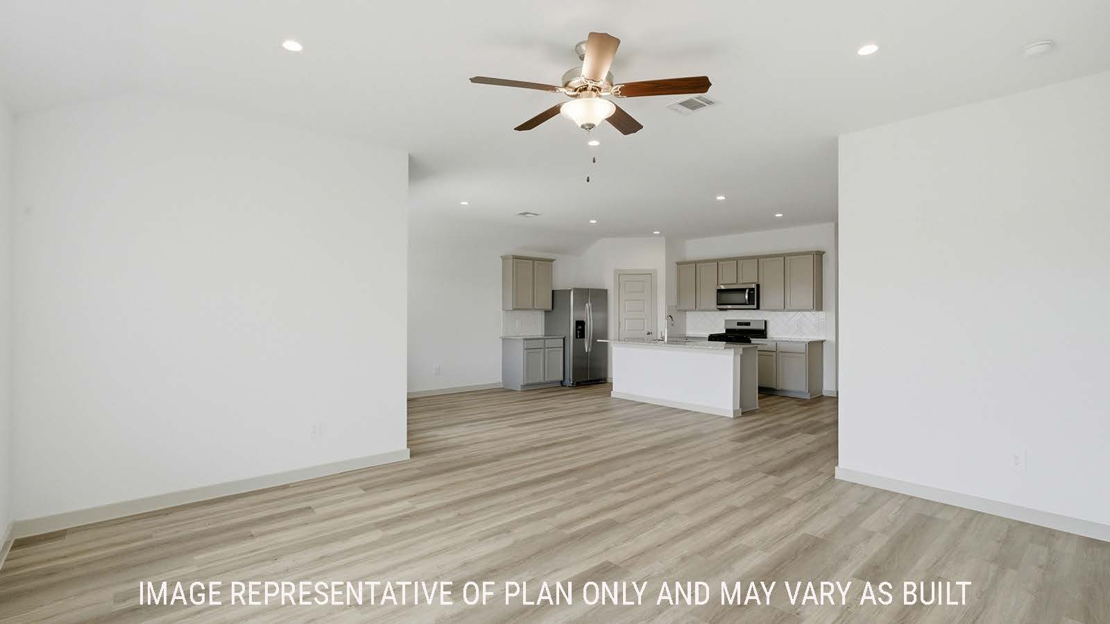 Texas Cali living room with vinyl plank flooring and view of open concept dining room and kitchen.